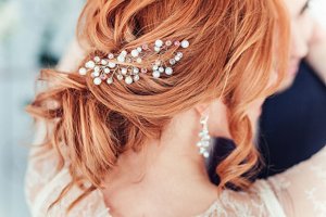 Bride with copper hair in a messy updo